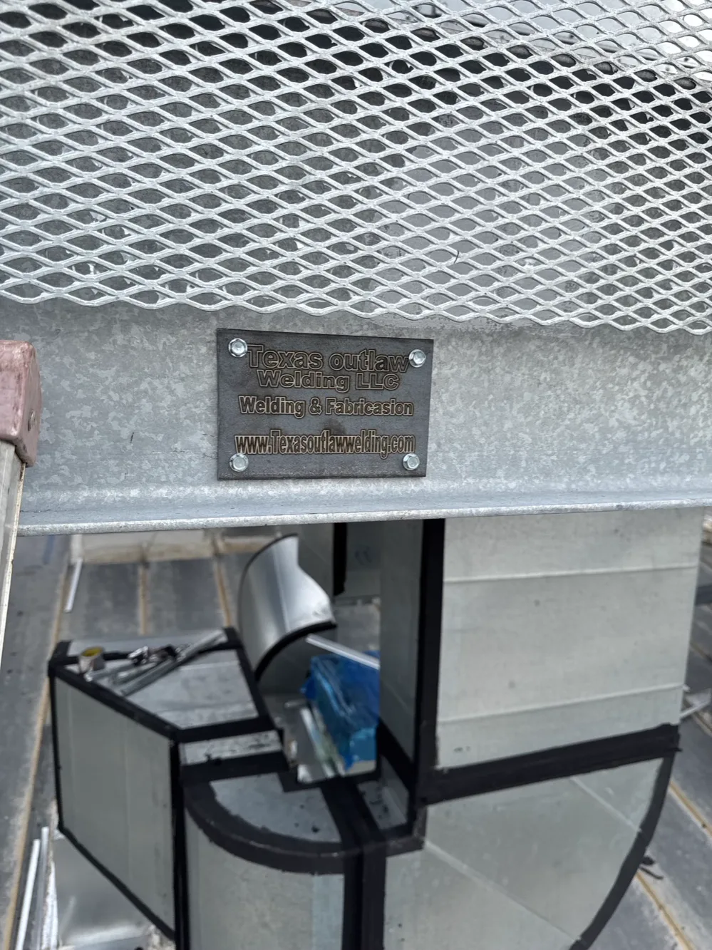 Galvanized steel platform with expanded-metal decking and a Texas Outlaw Welding maker’s plate
