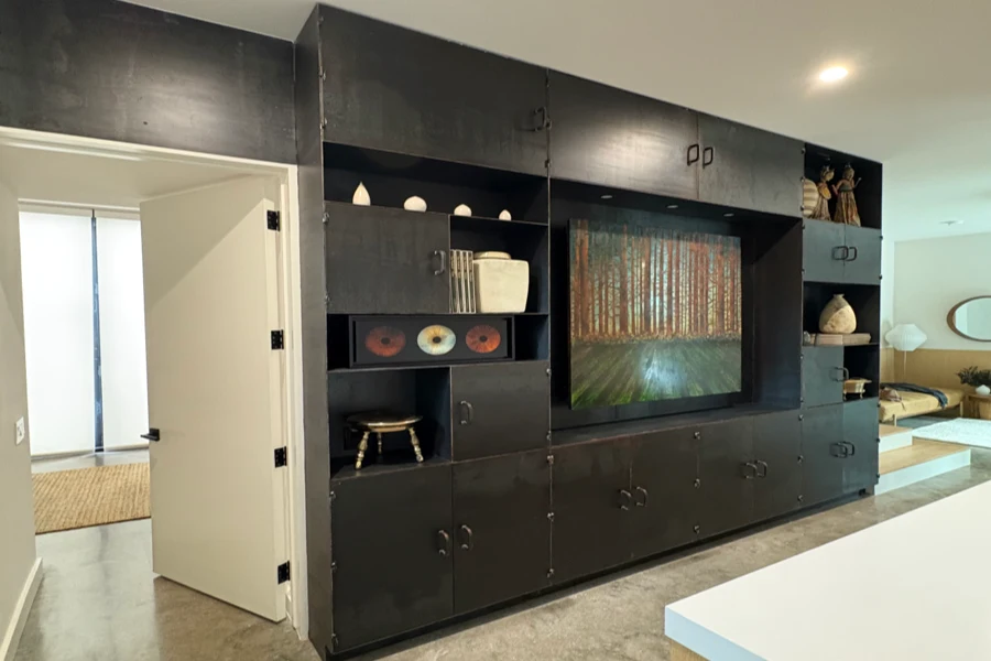 open-concept.webp Blackened steel built-in cabinetry and media wall at the 2510 Dryden residence
