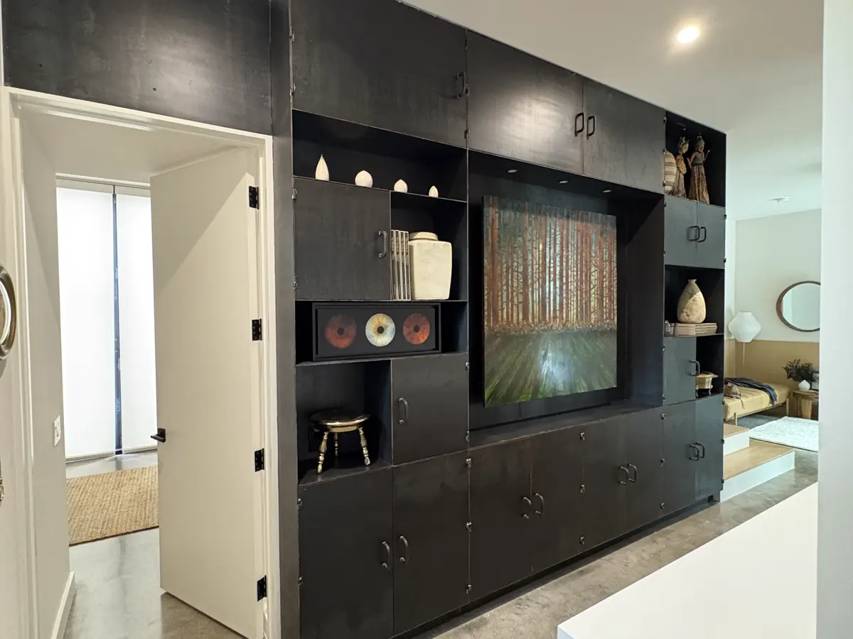Blackened steel built-in cabinetry wall fabricated for the 2510 Dryden residence