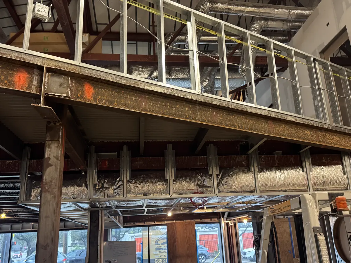 Structural steel beam, support columns and guardrail above the ground floor of the Recess project