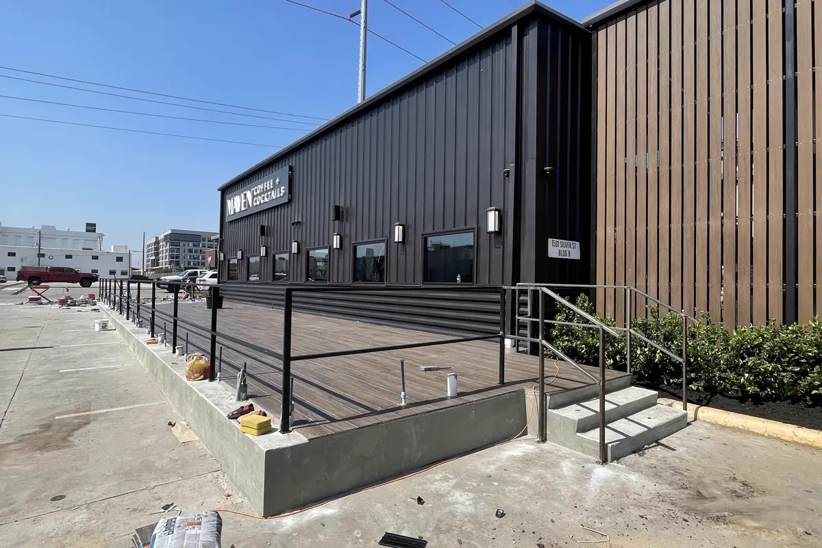 Metal-clad commercial building with steel guardrail during site works