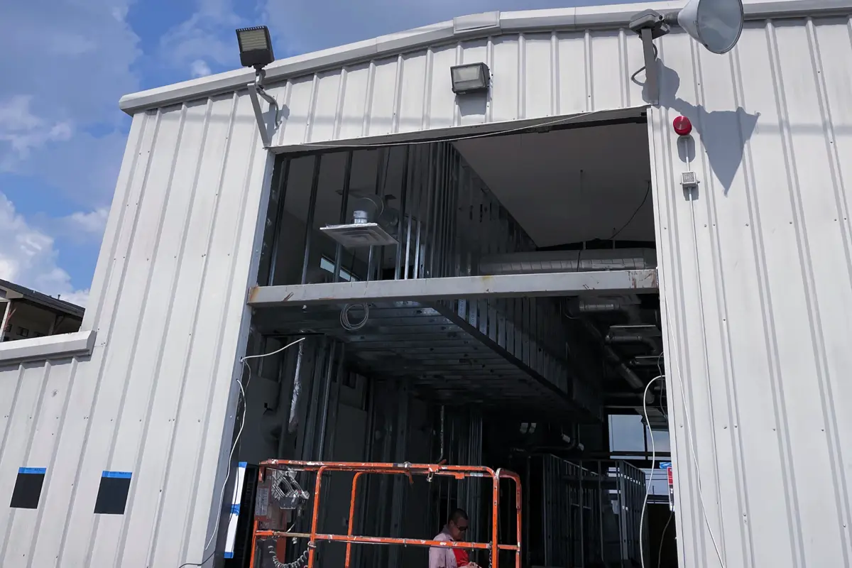 Pre-engineered metal building with interior steel framing visible through the opening
